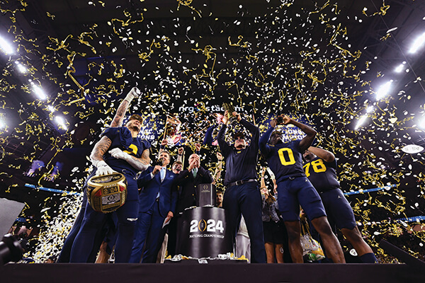 Football players and coaches getting covered in confetti after winning the national championship